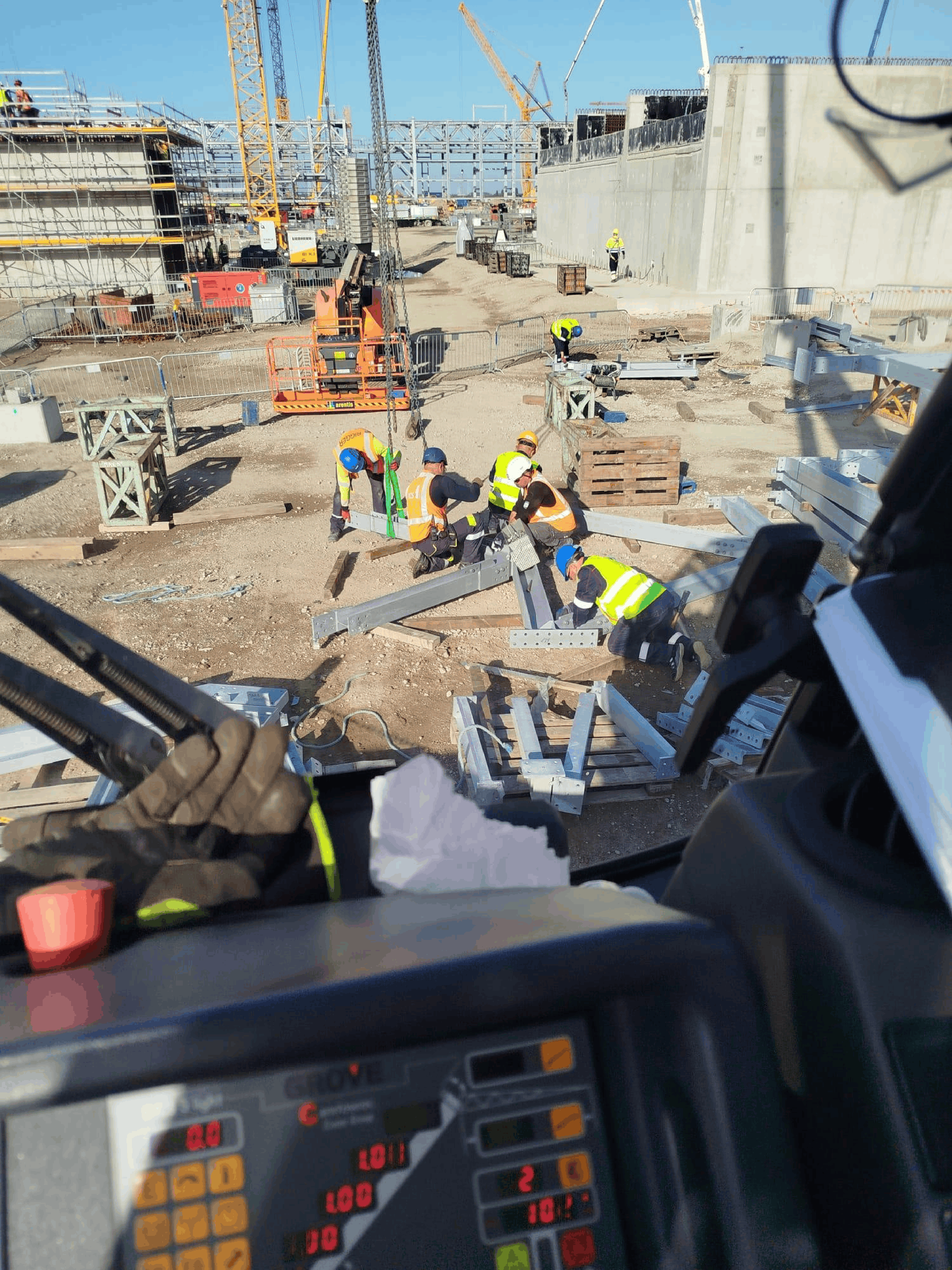View from crane cab looking down at PPE workers on site